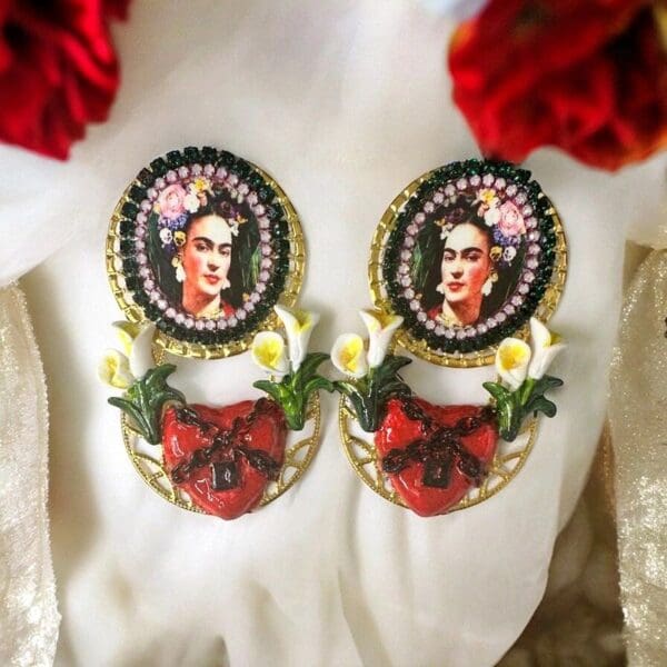A pair of earrings with flowers and a picture.