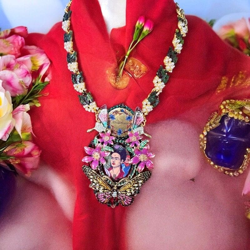 A woman wearing a necklace with flowers on it.