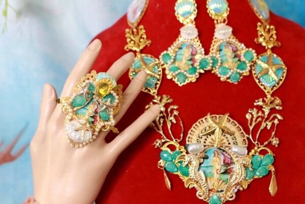 A woman 's hand is holding onto some jewelry