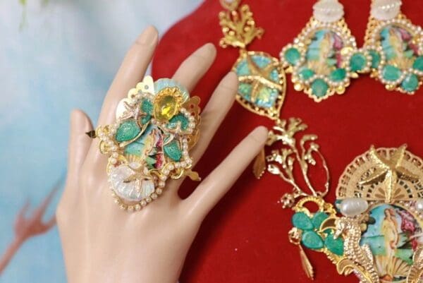 A woman 's hand with a ring on it and some jewelry