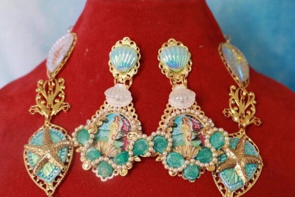 A red velvet display with some earrings and a necklace