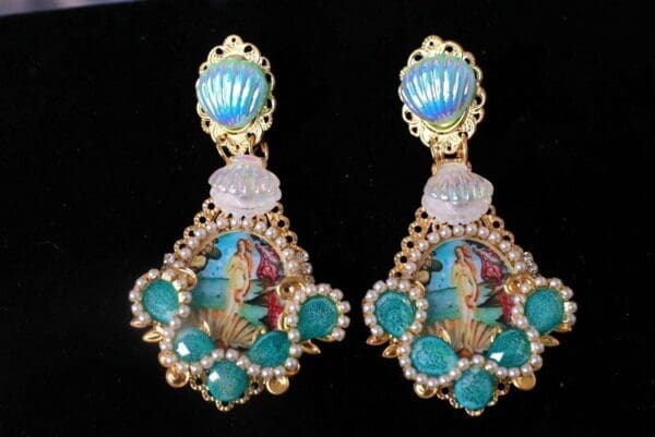 A pair of earrings with blue stones and gold