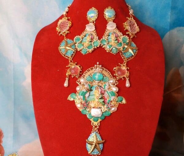 A red display with a necklace and earrings on it