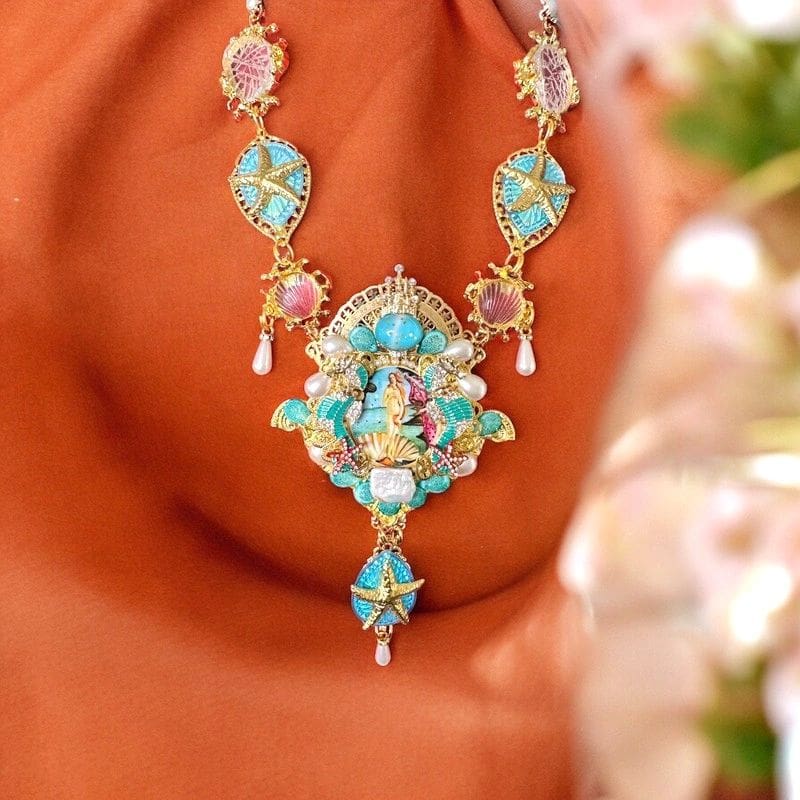 A woman wearing a necklace with an image of jesus.