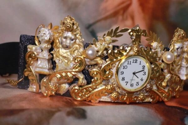 A gold clock sitting on top of some other things