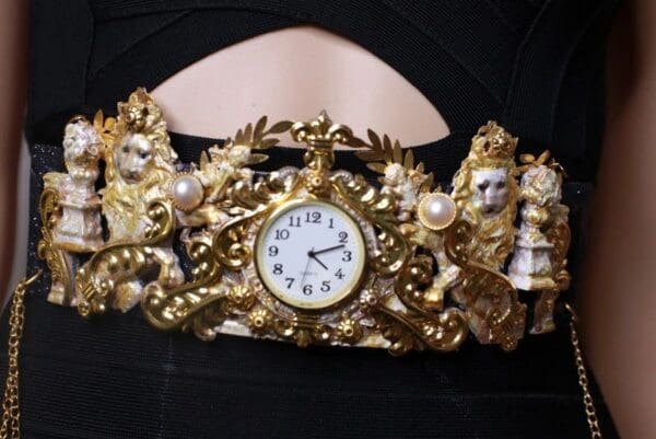 A gold crown with a clock on it
