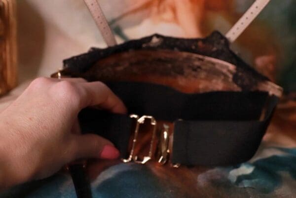 A person holding onto the strap of a purse