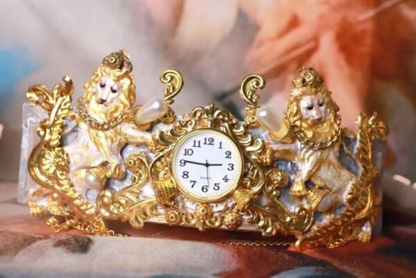 A gold crown with a clock on it