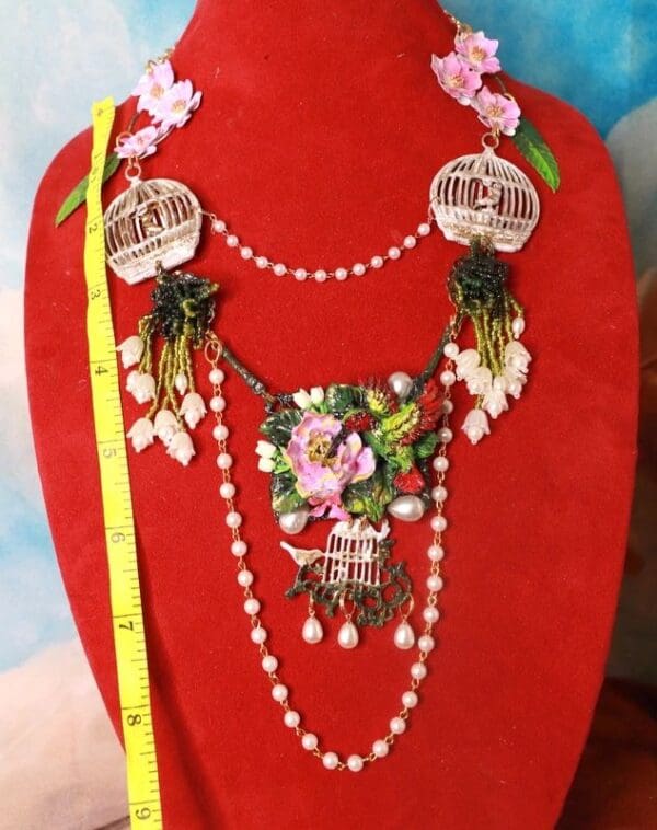 A red display case with a necklace and earrings.