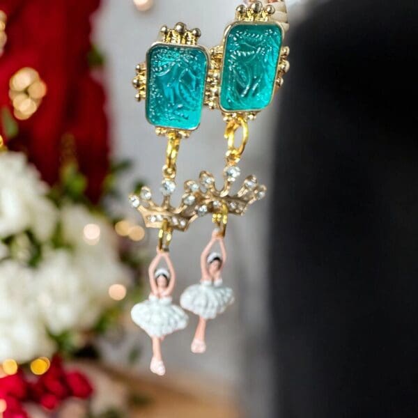 A pair of earrings with a ballerina and a nutcracker.
