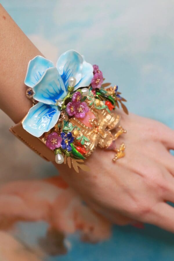 A woman wearing a bracelet with flowers on it.