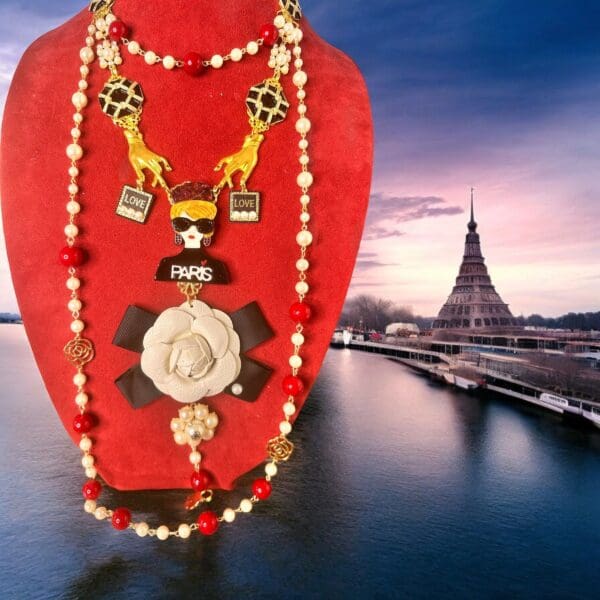 A red necklace with a giraffe and other jewelry on it.