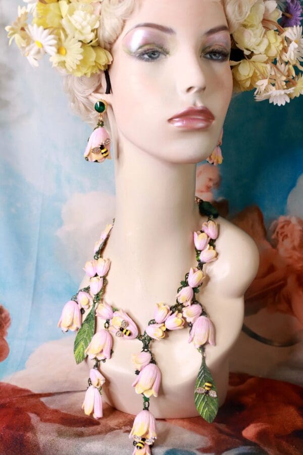A mannequin wearing pink and green jewelry.