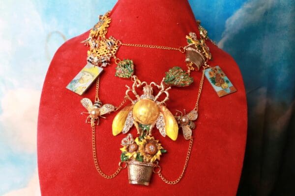 A necklace with a bee and flowers on it