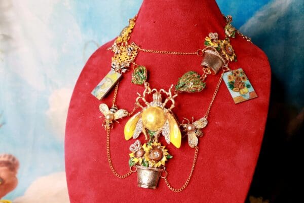 A red necklace with a bee and flowers on it