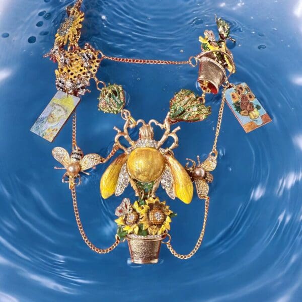 A necklace with bees and flowers in water.