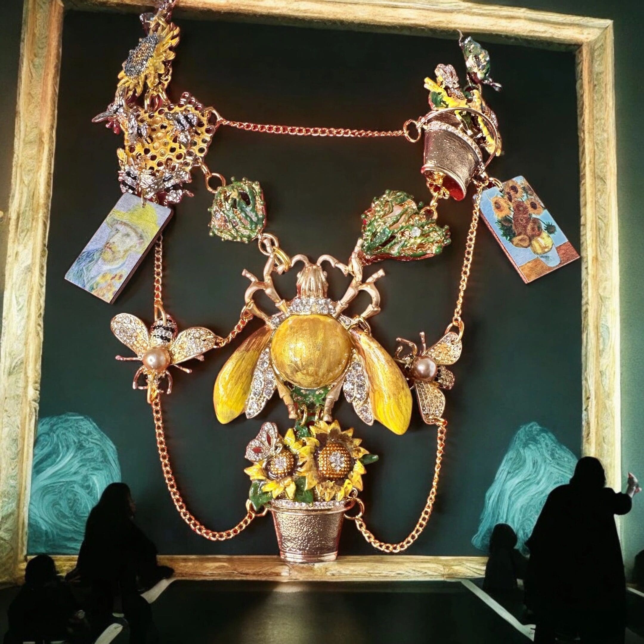 A large picture frame with a bee and flowers hanging from it.