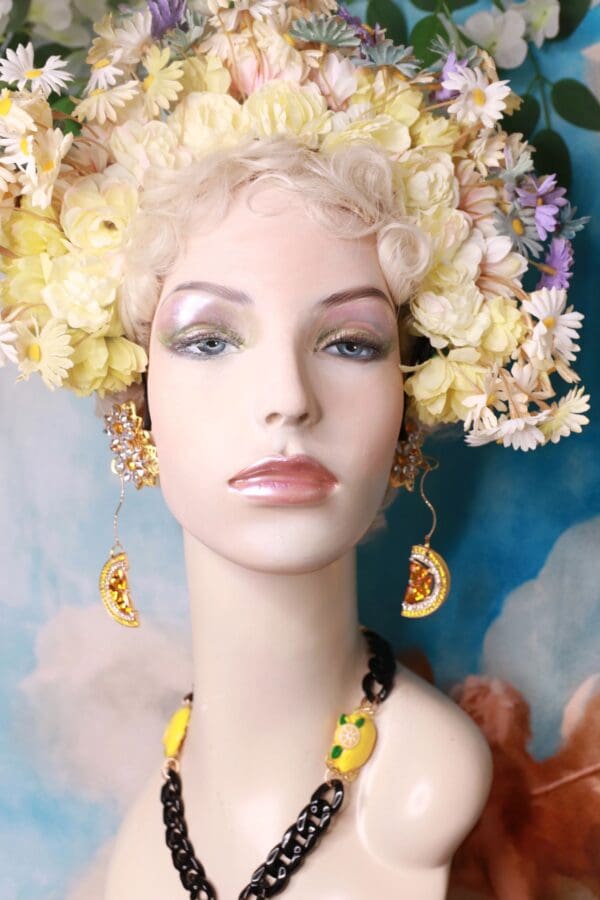 A mannequin with flowers in her hair and earrings.