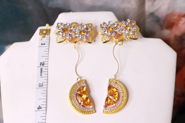 A pair of earrings with gold and diamond slices.
