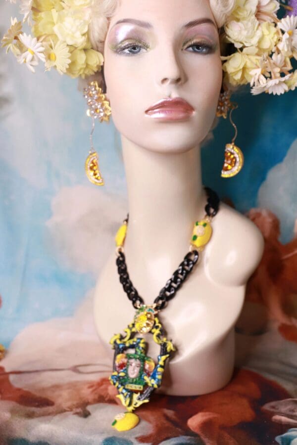 A mannequin wearing a necklace and earrings.