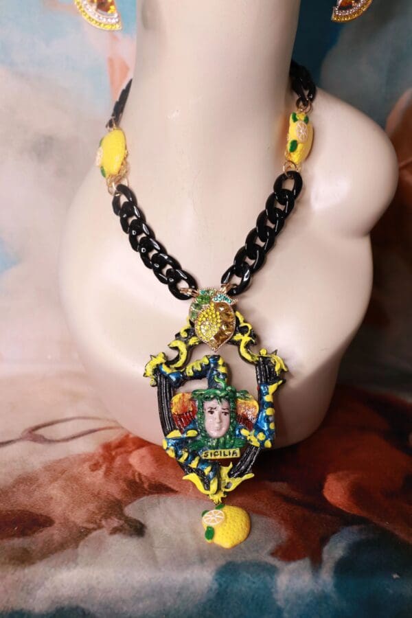 A necklace with a picture of a woman wearing a hat.