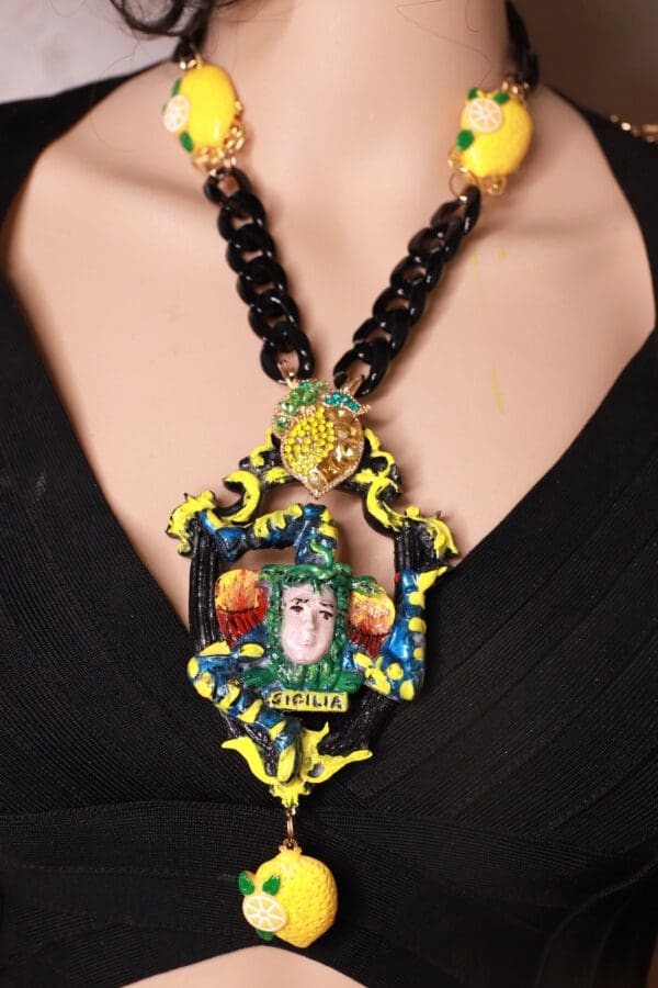 A woman wearing a necklace with a picture of a person.