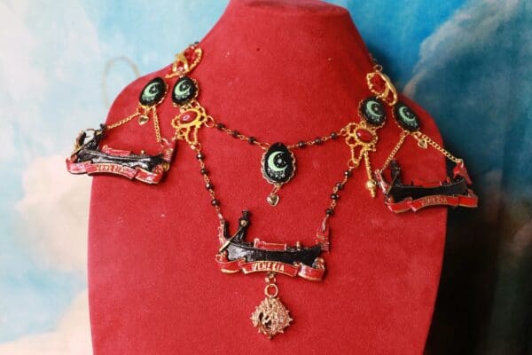 A red display with a necklace and earrings on it