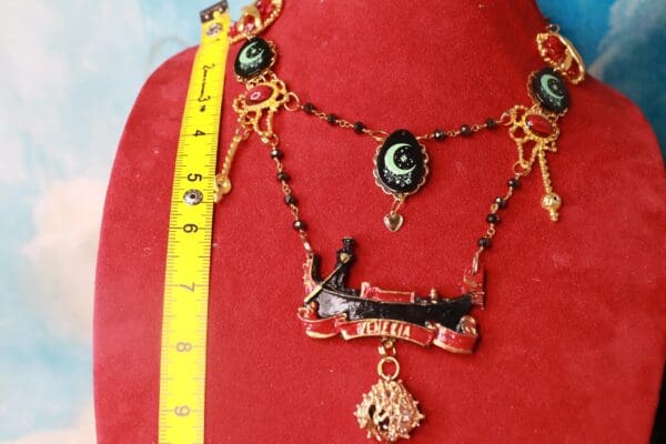 A red velvet display with a necklace and measuring tape.
