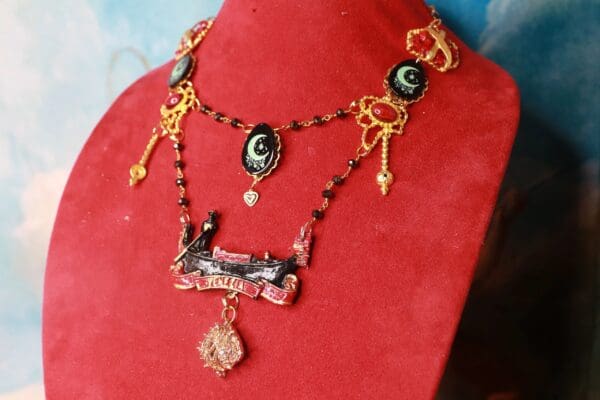 A red display with a necklace and some gold chains