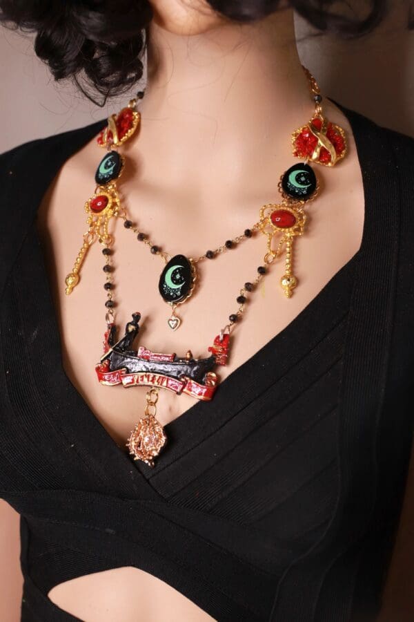 A woman wearing a necklace with different types of jewelry.
