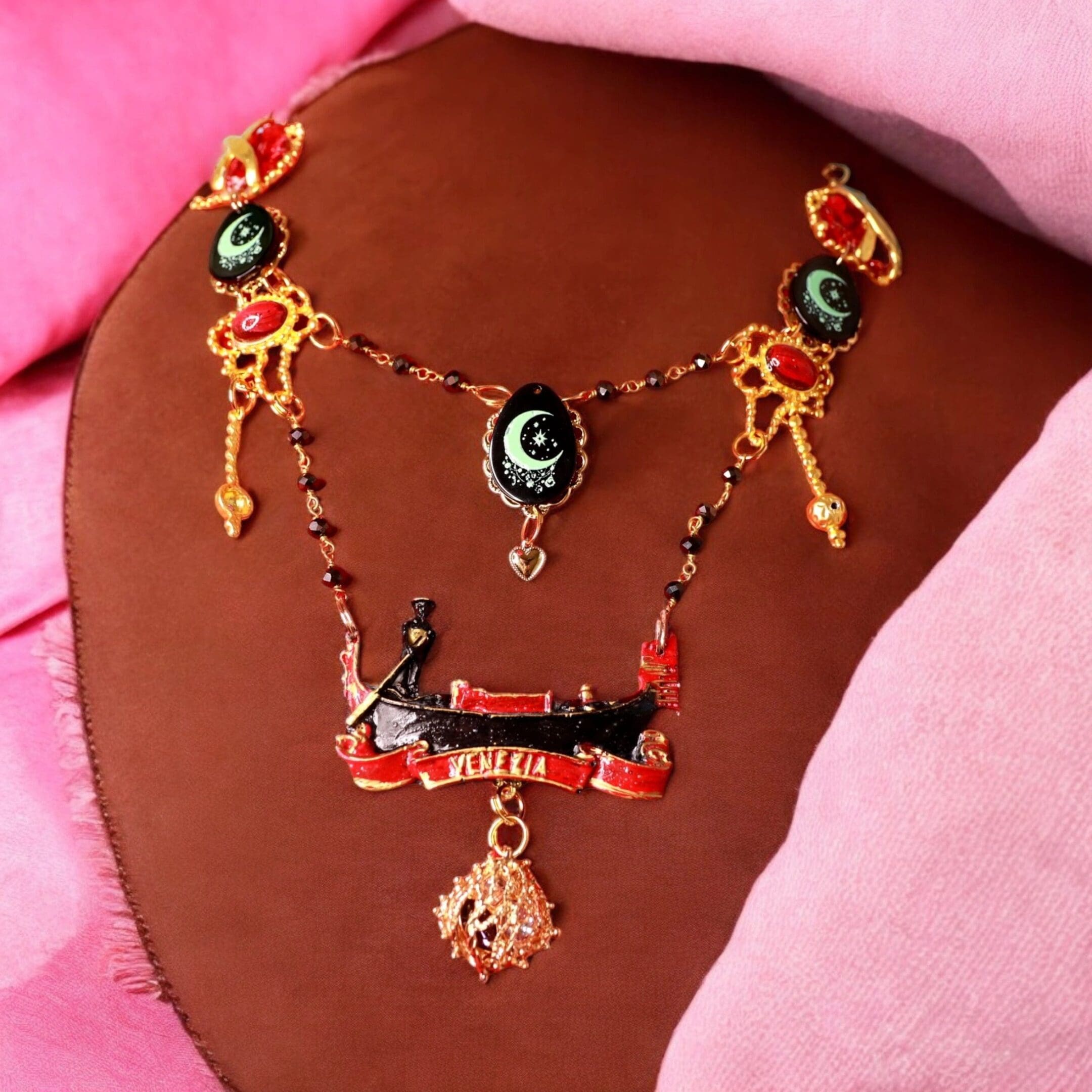 A necklace with a dragon and other decorations.
