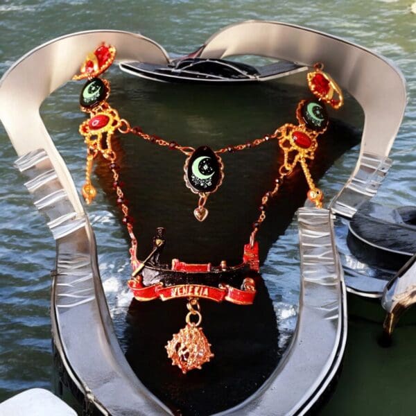 A necklace with red and green beads on the neck of a boat.