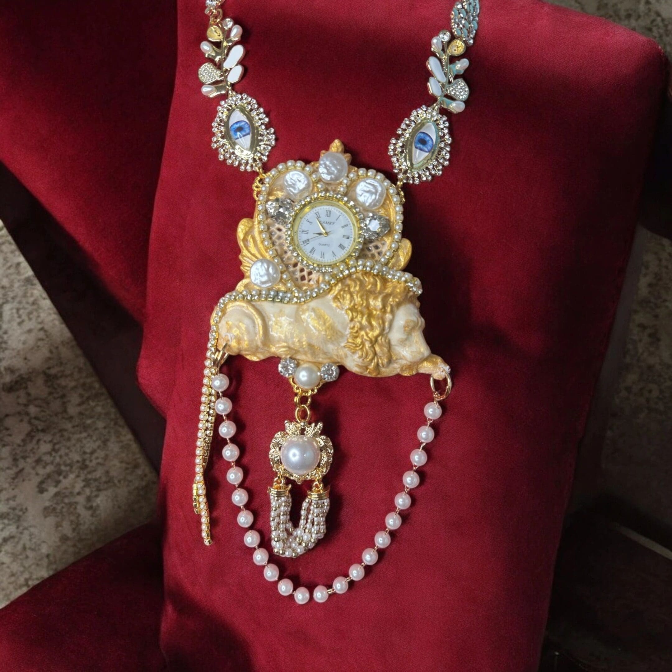 A red chair with a necklace and some gold