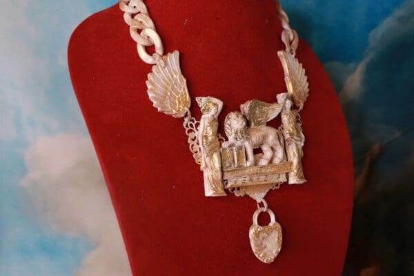 A red velvet bag with a necklace on it