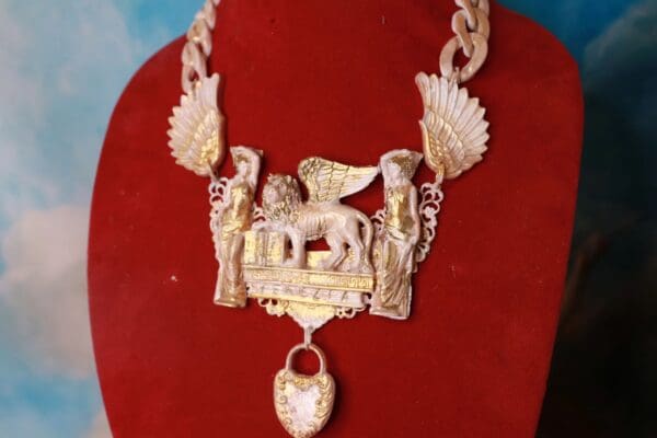 A necklace with an eagle and a horse on it.
