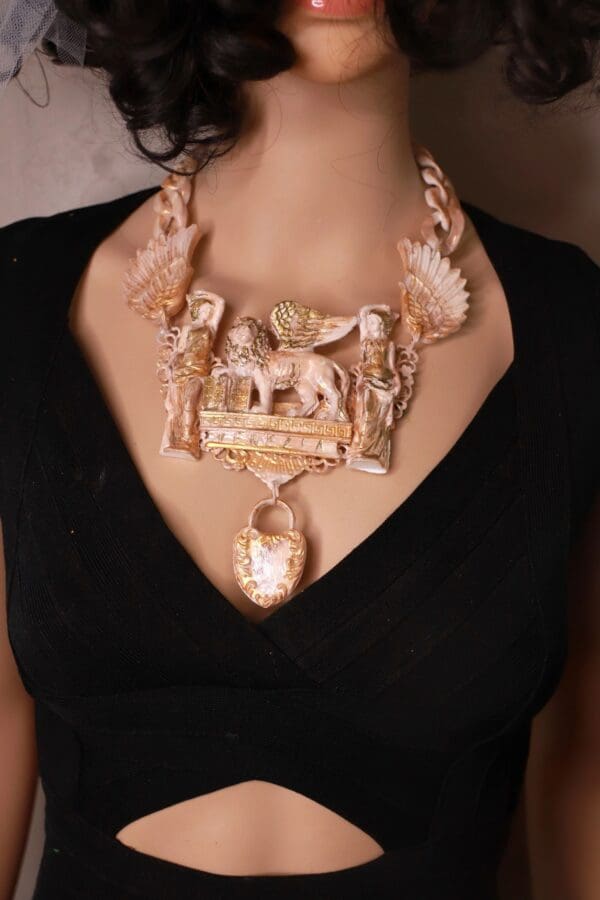 A woman wearing a necklace with an elephant on it.