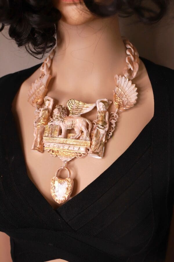 A woman wearing a necklace with an elephant and other animals.