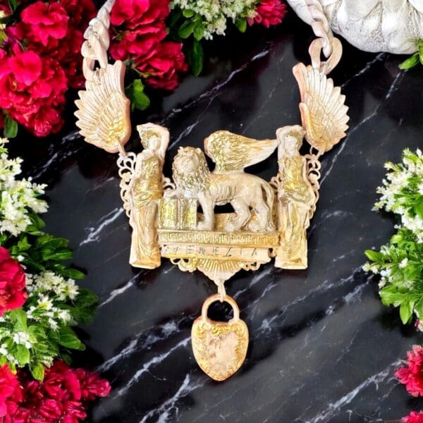 A necklace with flowers and a key on it
