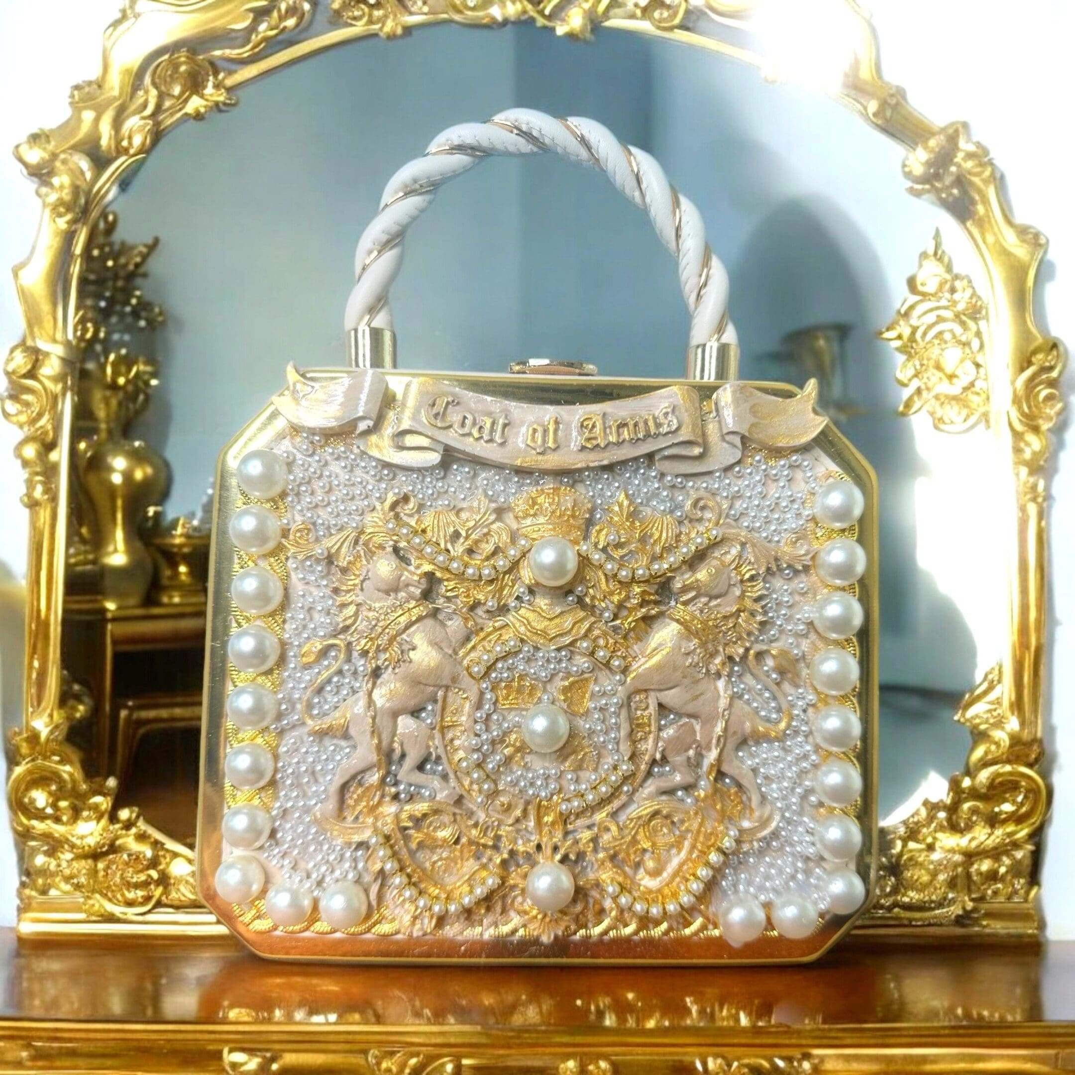 A gold and white purse sitting on top of a table.