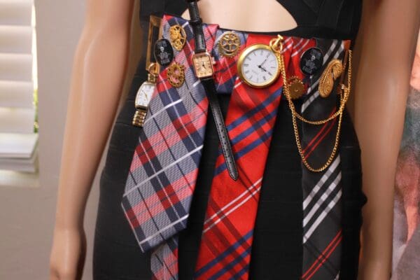 A woman wearing many ties with different designs on them.