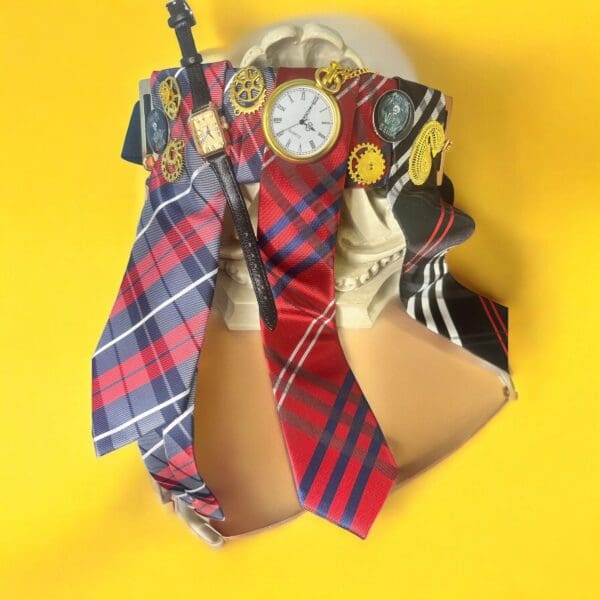 A clock and some ties on top of a yellow wall.