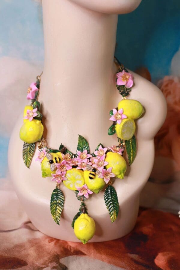 A necklace with lemons and flowers on it