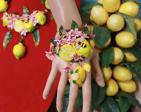 A hand with lemons and flowers on it