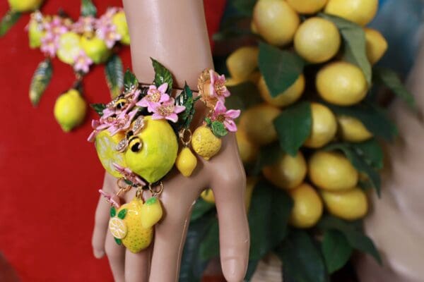 A hand with lemons and flowers on it