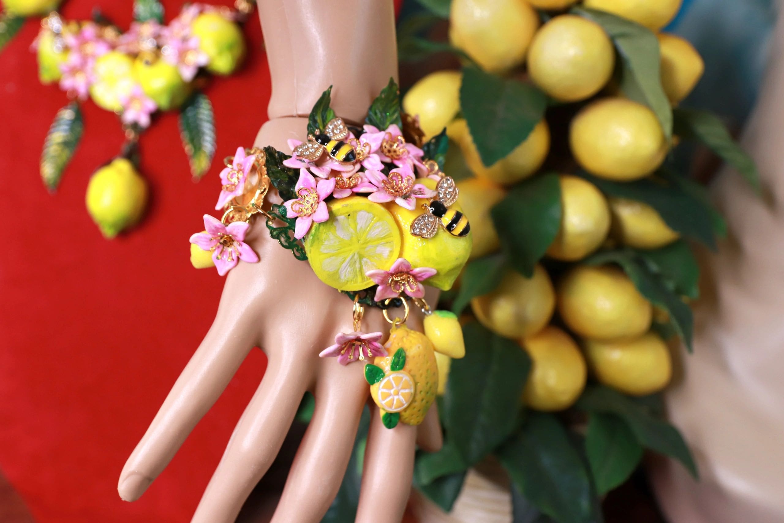 A hand with some lemons and flowers on it