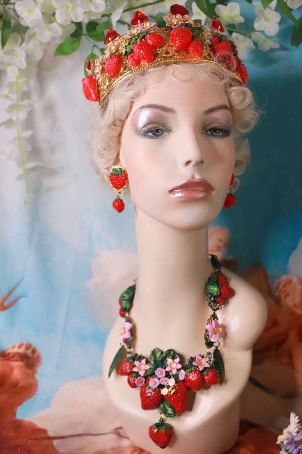 A mannequin wearing jewelry and earrings in front of a painting.