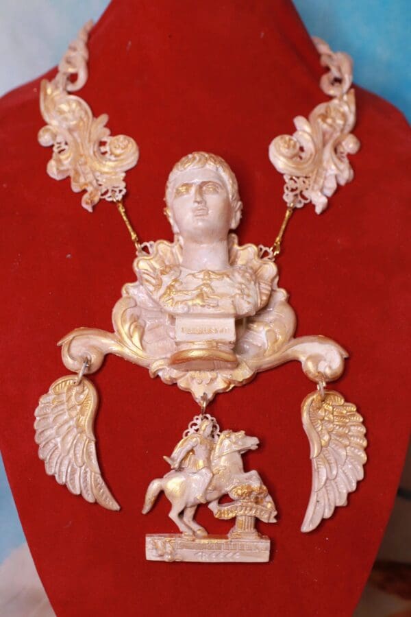 A red velvet chair with gold and white decorations.