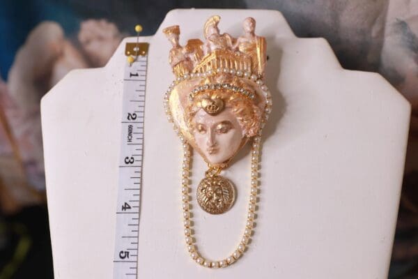 A gold crown with pearls and a ruler