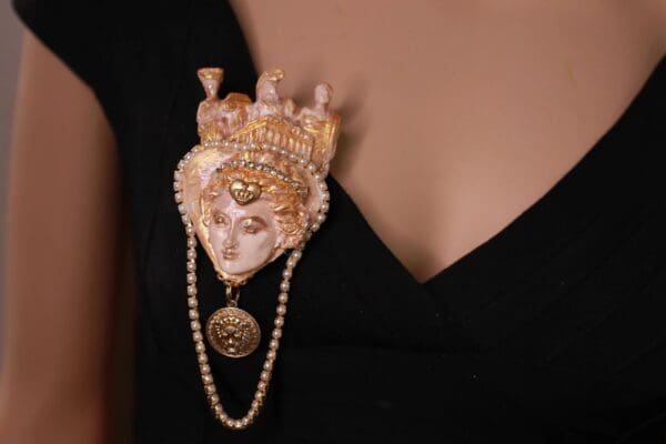 A woman wearing a black dress and pearls