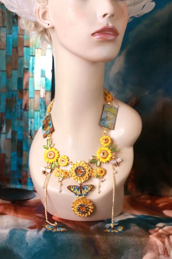 A mannequin wearing a necklace with sunflowers and butterflies.